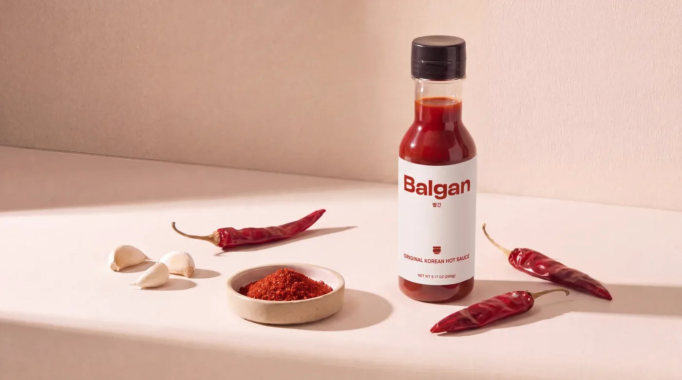 Gochujang hot sauce bottle on cream backdrop