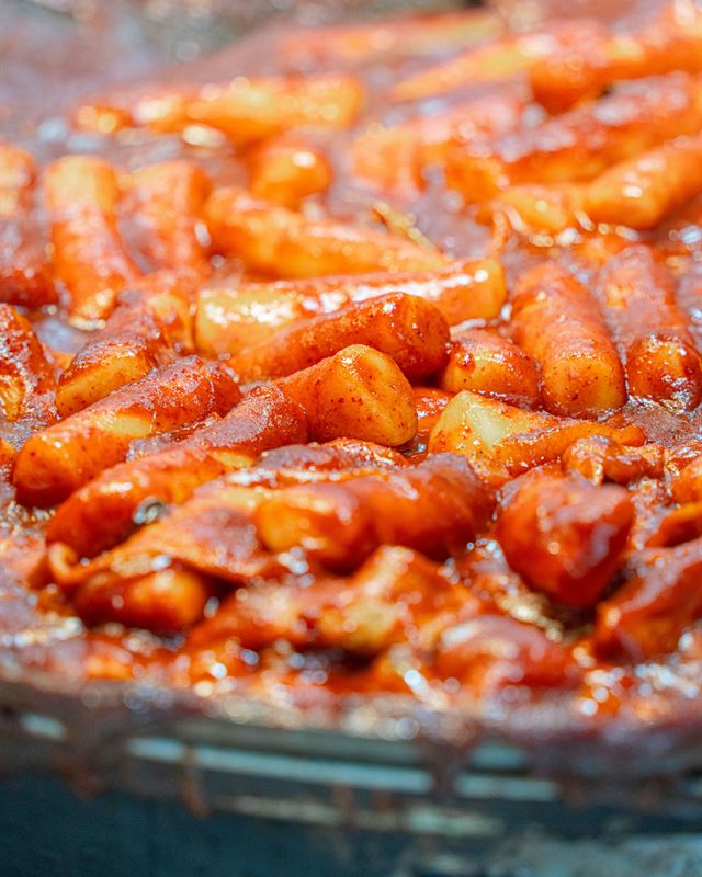 Tteokbokki rice cakes simmering in red gochujang sauce