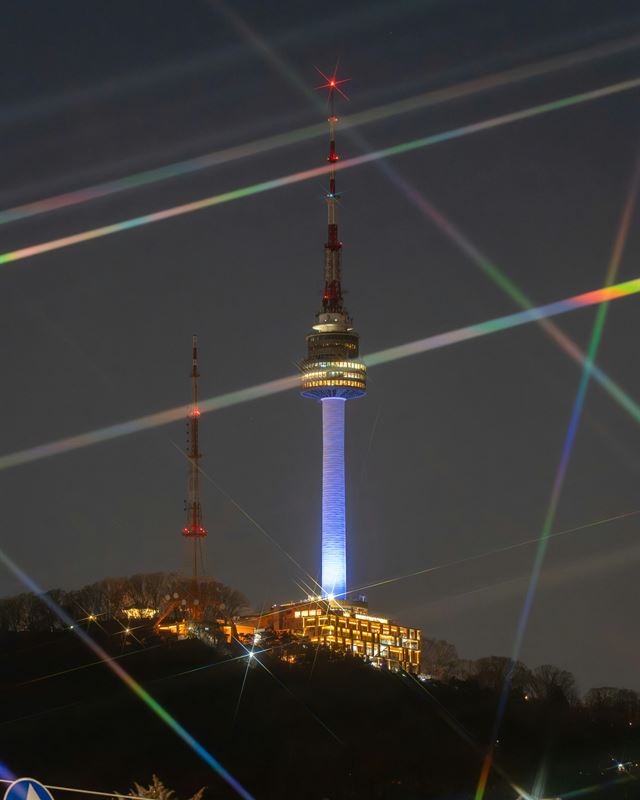 N Seoul Tower lit at night above the city