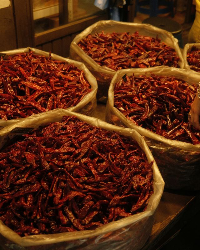 Sacks of dried Korean red chilies at a market stall