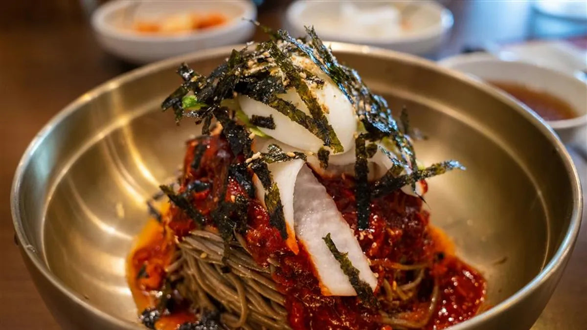 Sweet and spicy Korean cold pasta with cucumber, kimchi and a soft-boiled egg